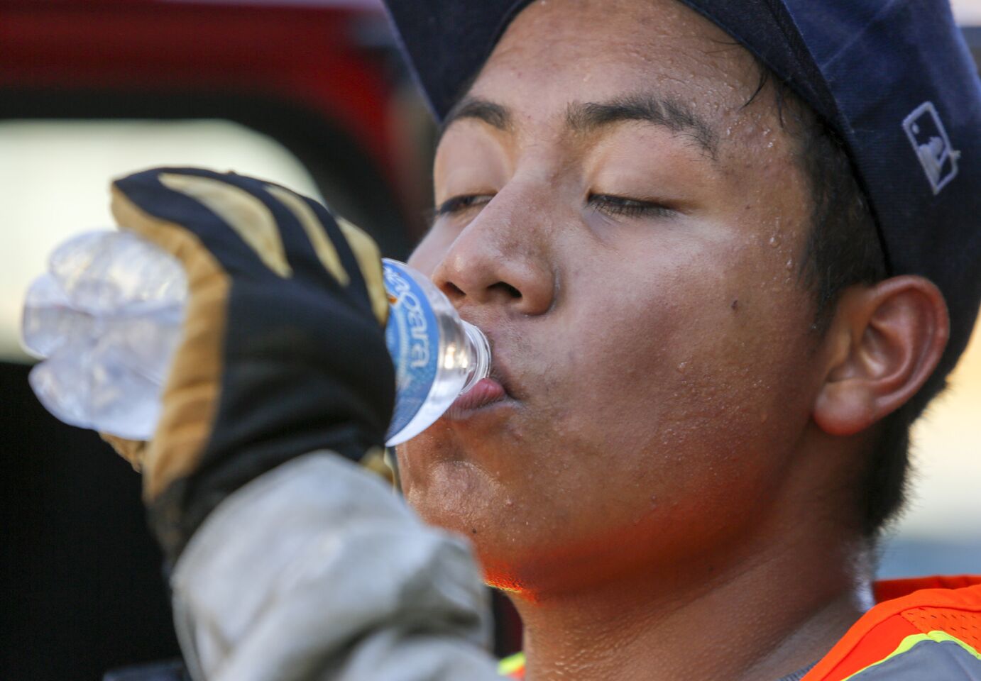 Moises Lopez takes a water break from landscaping a San Gabriel Mission school to stay hydrated.