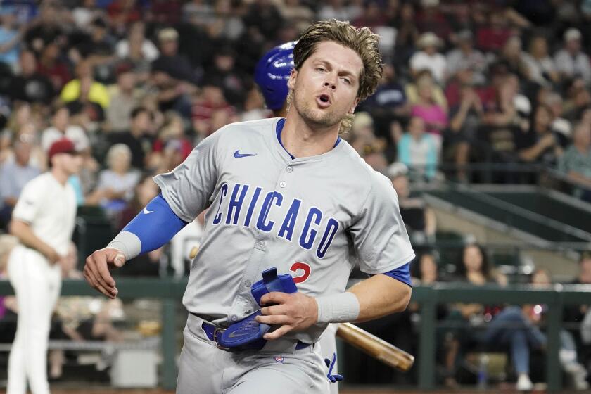 Chicago Cubs' Nico Hoerner (2) scores their first run against the Arizona Diamondbacks during the fifth inning of a baseball game Wednesday, April 17, 2024, in Phoenix. (AP Photo/Darryl Webb)