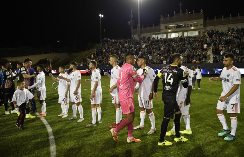 Players from the San Diego Loyal and Las Vegas Lights shake hands before the Loyal's inaugural game last March at USD.