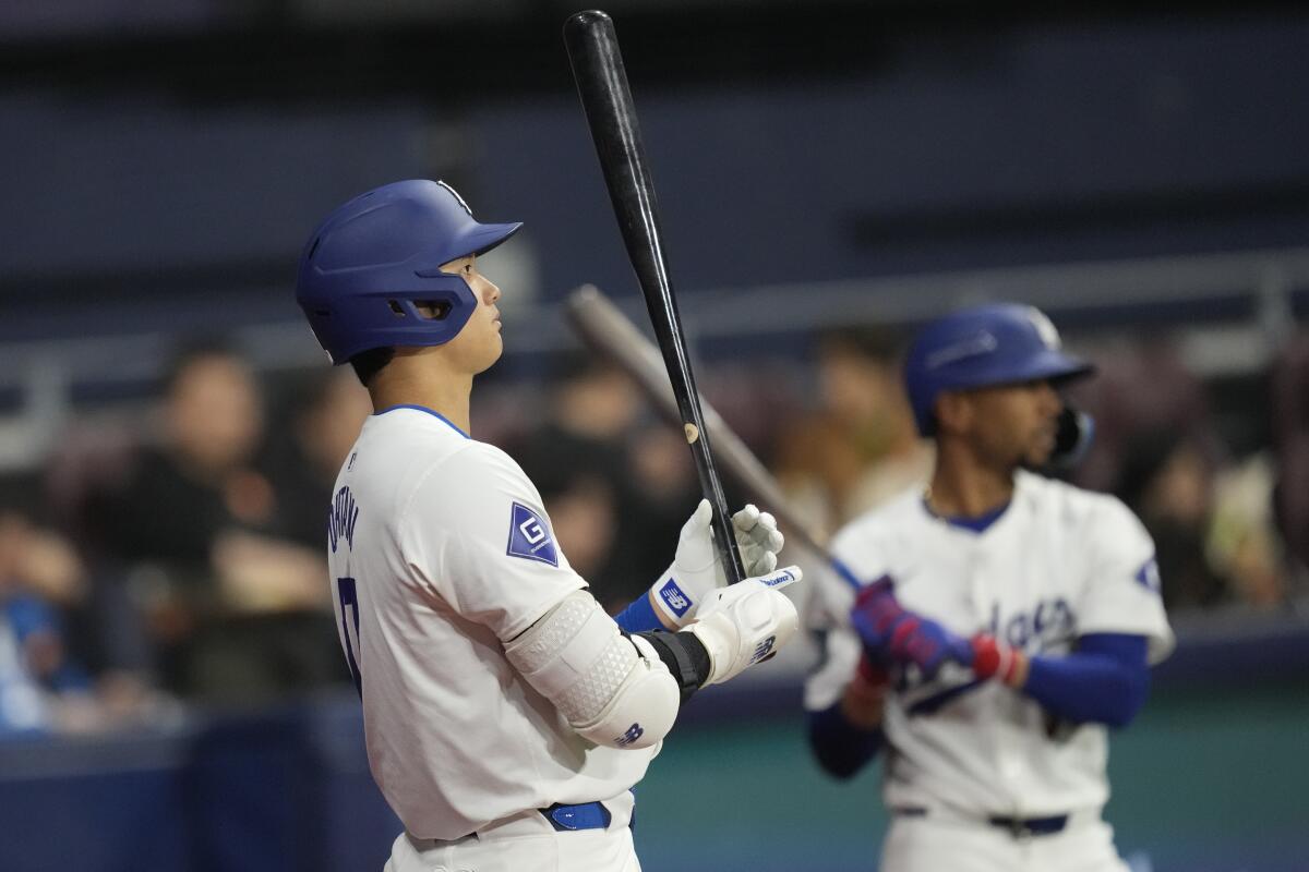 Shohei Ohtani, left, and Mookie Betts prepare near the on-deck circle before an exhibition game on Monday in Seoul.