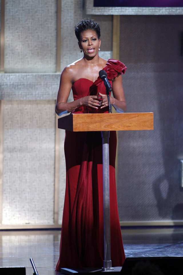 The first lady, in an elegant one-shoulder red gown, introduces BET honoree Maya Angelou during the BET Honors at the Warner Theatre in Washington in January 2012.
