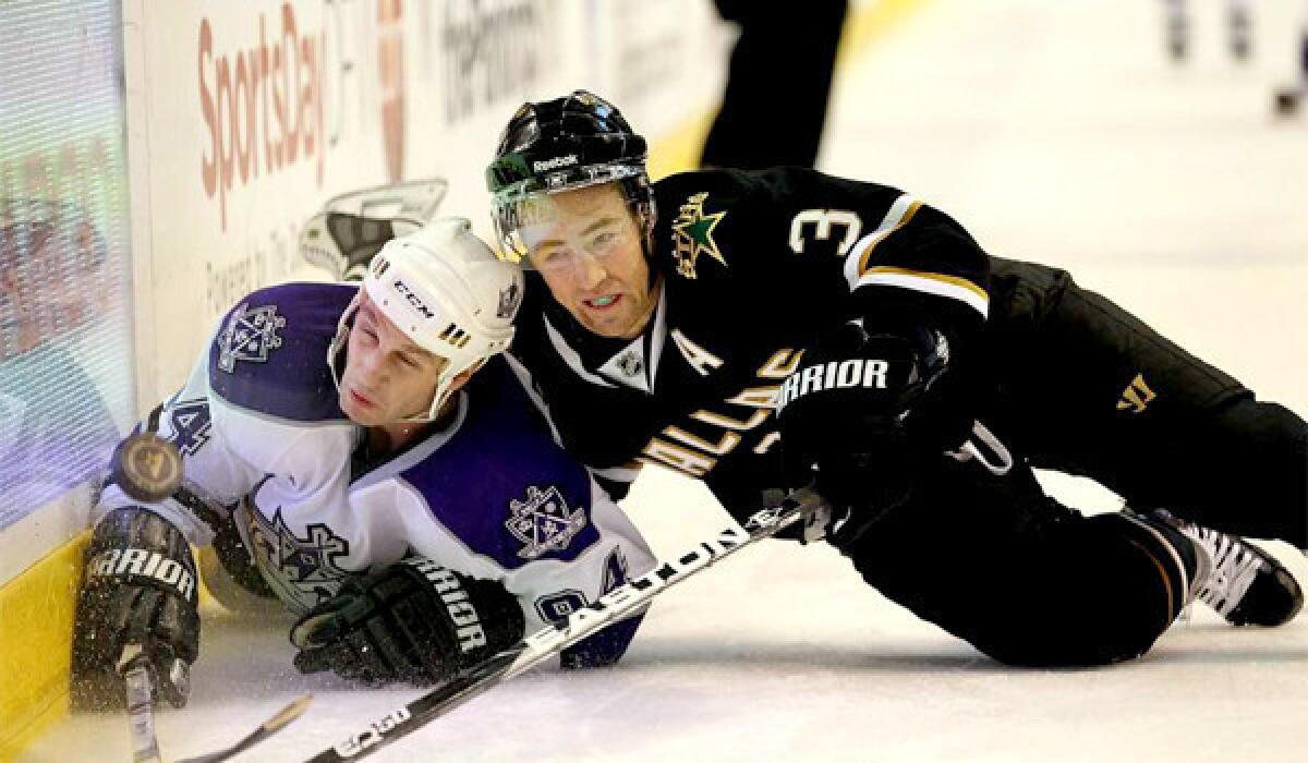 Staphane Robidas, who the Ducks aquired from the Dallas Stars because of his physical style of play, puts the Kings' Ryan Smith to the ice along the boards during a game on Jan. 17, 2011.