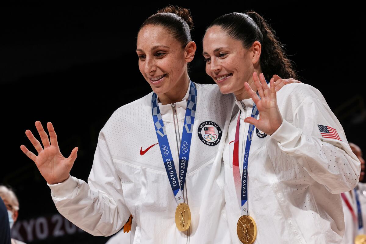 U.S. women's basketball stars Diana Taurasi and Sue Bird show off their Olympic gold medals.