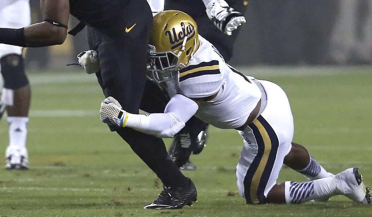 Ishmael Adams makes a tackle for UCLA in September 2014.