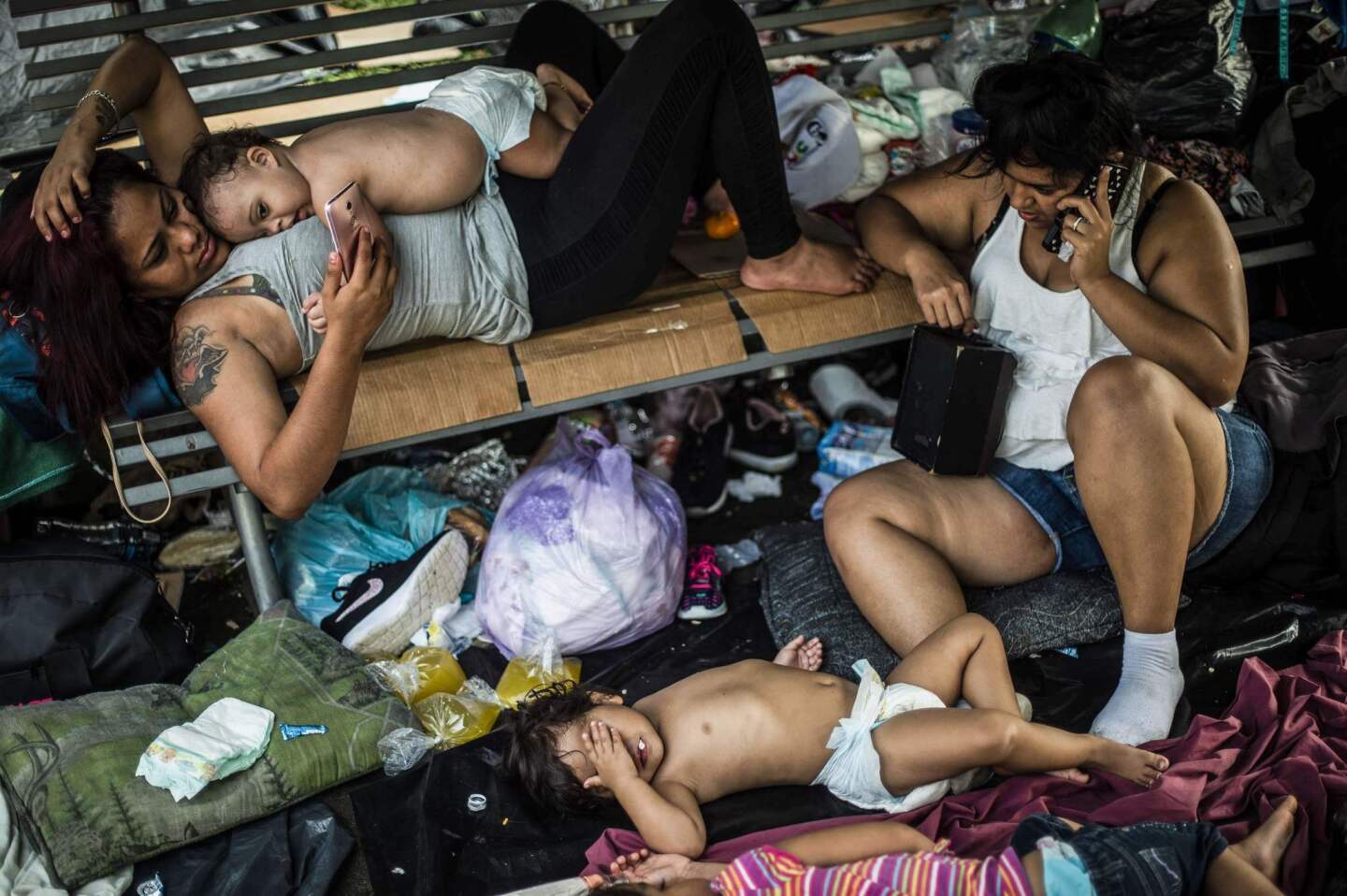 Honduran migrants taking part in a caravan heading to the U.Ss, rest at a makeshift camp during a stop in Huixtla, Mexico.