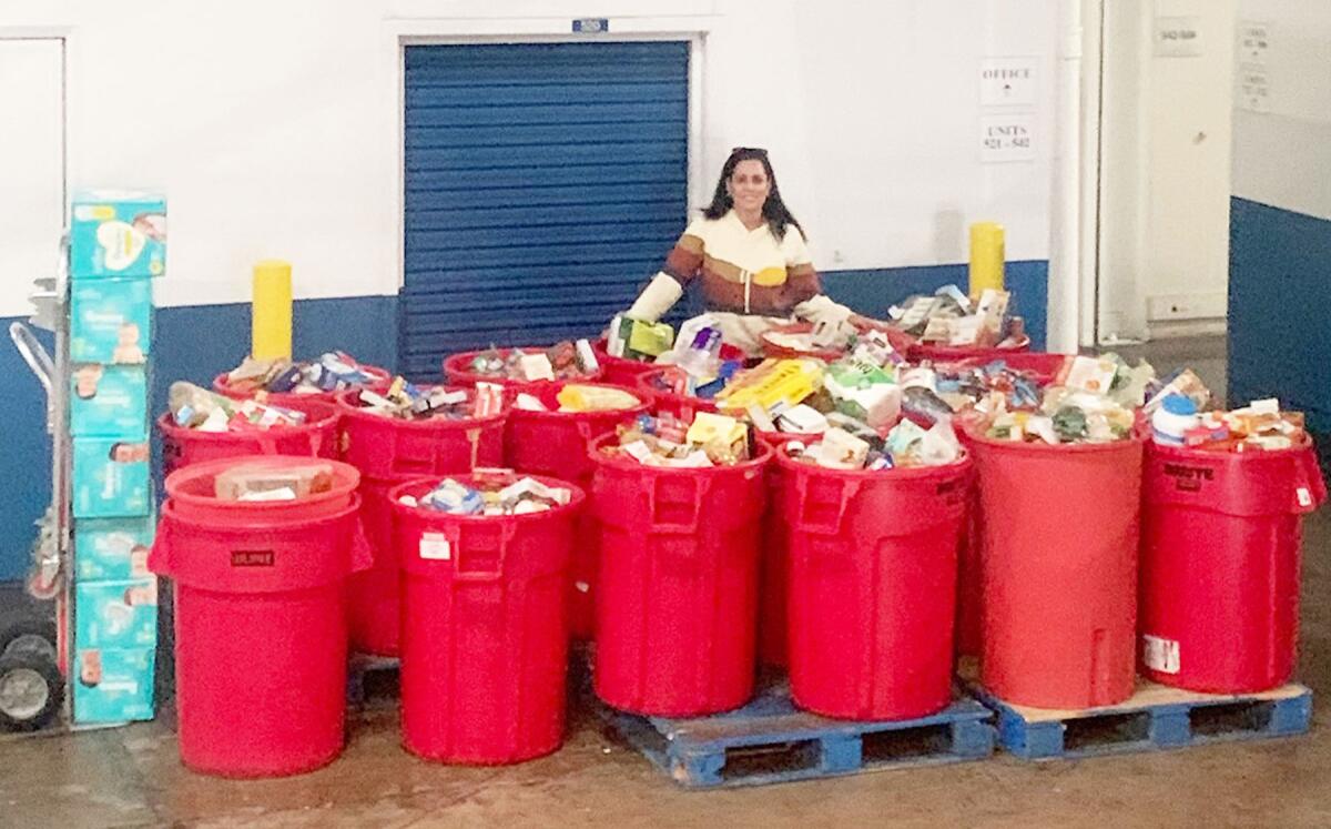 Candi DeMoura, founder of the Heart to Hands Food Drive, with donations received from those in Pacific Beach and La Jolla.