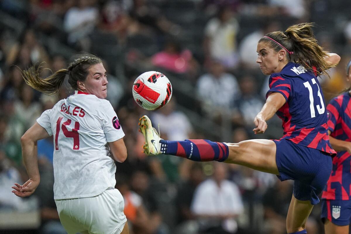 The United States' Alex Morgan controls the ball against Canada's Vanessa Gilles during the CONCACAF W Championship final.