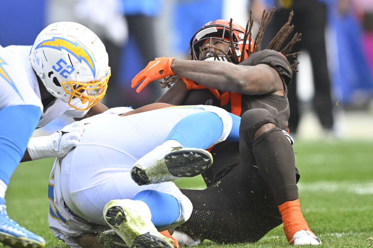 The Chargers' Christian Covington tackles the Browns' Kareem Hunt in the backfield on a fourth-down play.
