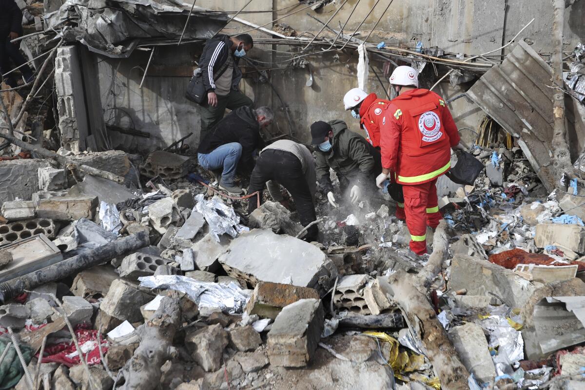 Paramedic workers search for victims in the rubble of a paramedic center.