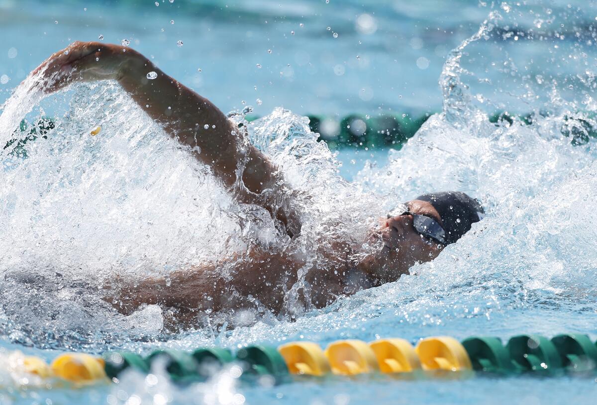 Luke Porturalski, of Huntington Beach swims the backstroke in the opening leg of the boys' IM relay.