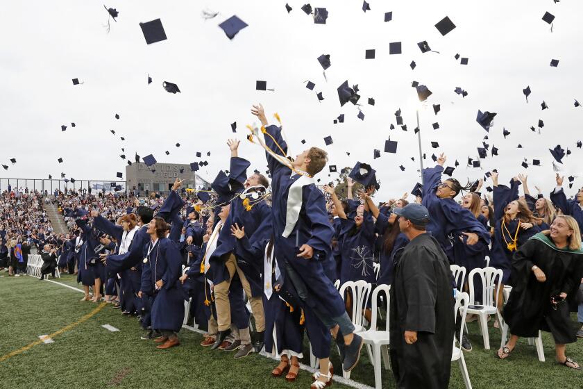 Graduates toss their caps in celebration at the end of Newport Harbor High School's 2019 graduation ceremony Thursday at Davidson Field.