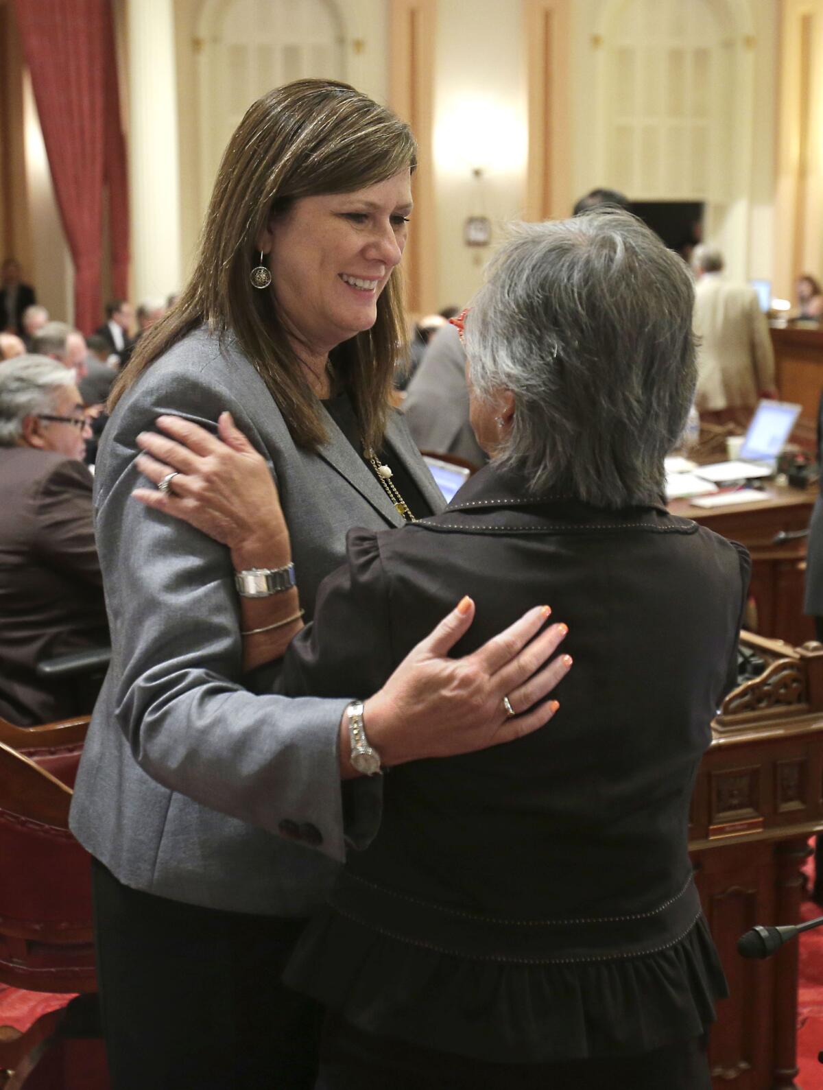 Assemblywoman Susan Bonilla (D-Concord), left, hugs Sen. Carol Liu (D-La Canada Flintridge) after the Senate approved Bonilla's bill to overhaul student testing. The Assembly passed the bill Wednesday.