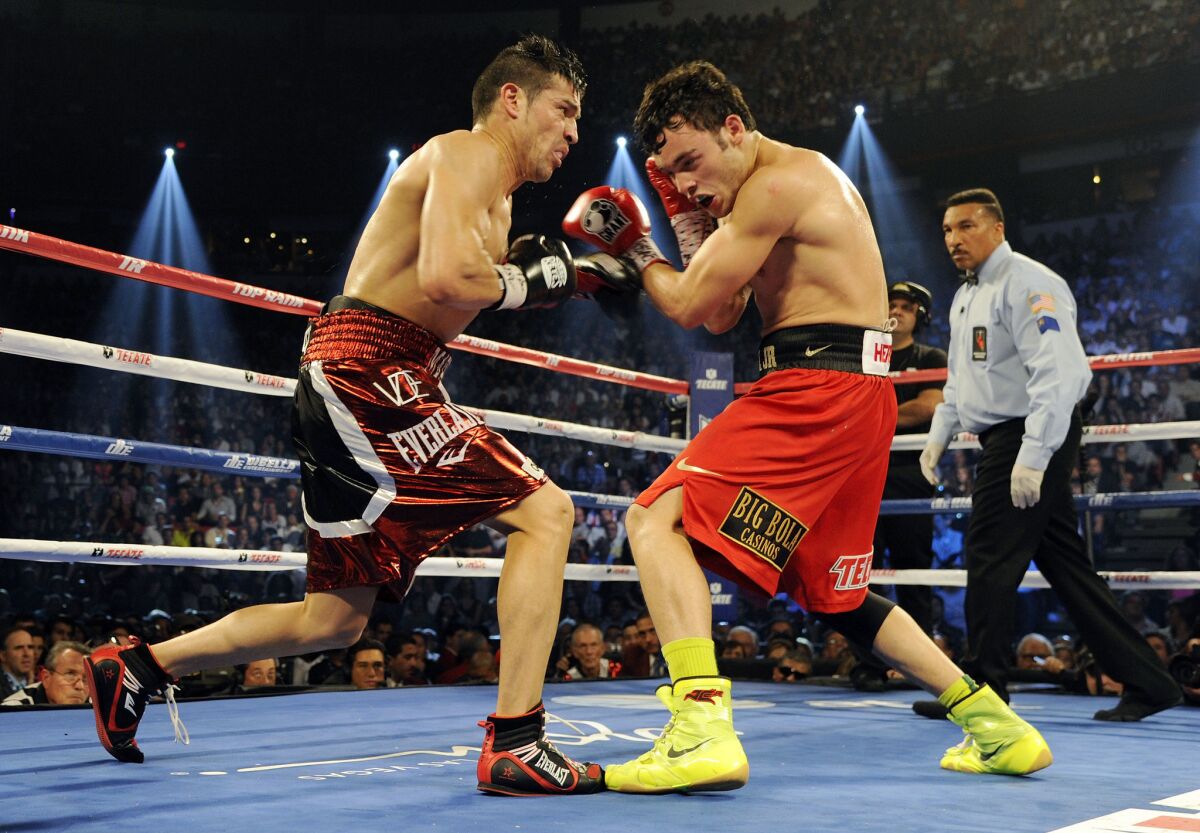Sergio Martinez (L) trades punches with Julio Cesar Chavez Jr. in the fourth round of their WBC middleweight title fight at the Thomas & Mack Center on September 15, 2012 in Las Vegas, Nevada.