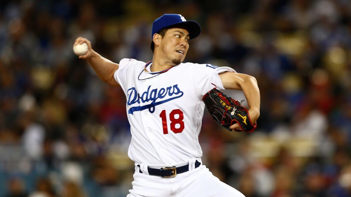 Dodgers starting pitcher Kenta Maeda (18) pitches against the Cincinnati Reds.