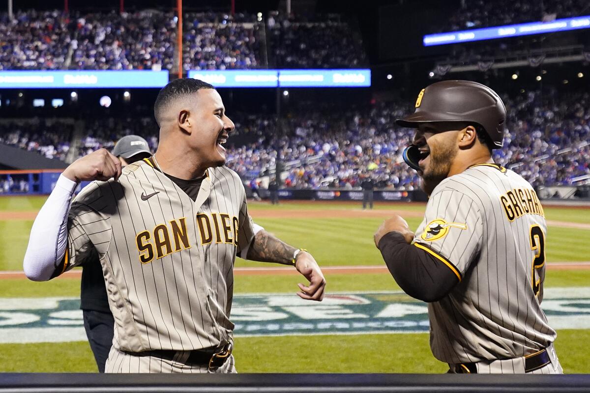 San Diego Padres Manny Machado congratulates center fielder Trent Grisham after Grisham hit a solo home run.