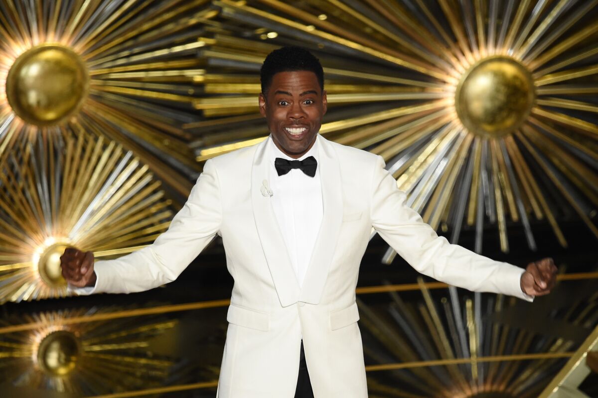 Chris Rock speaks onstage during the Academy Awards ceremony at the Dolby Theatre in Hollywood on Sunday.