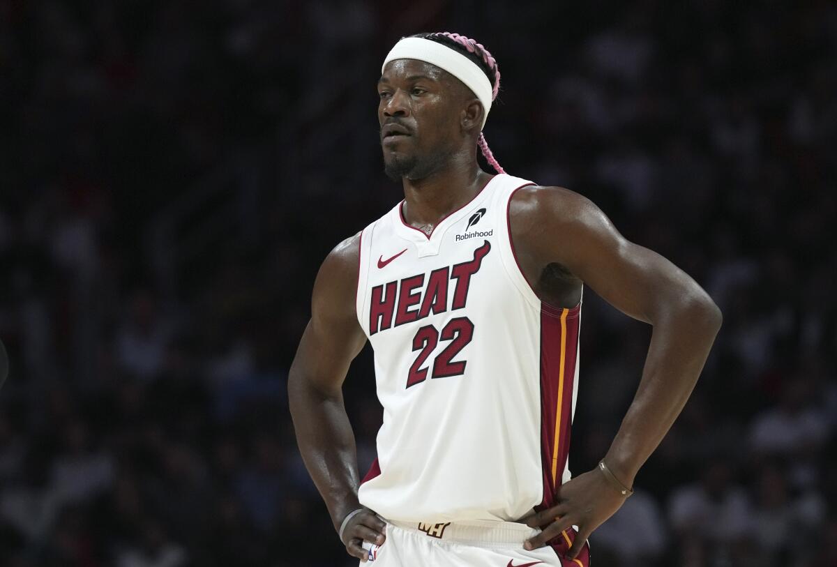 The Miami Heat star Jimmy Butler stands on the court during a game.