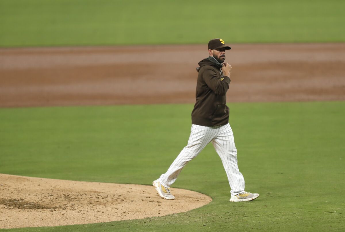 Padres manager Jayce Tingler walks off the mound during a game against the Mariners on Sept.19.