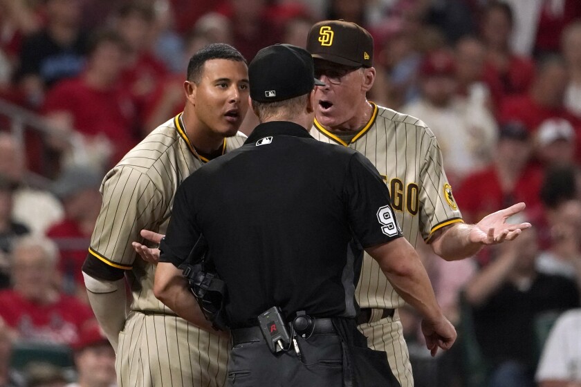 The Padres' Manny Machado, left, and manager Bob Melvin, right, argue with home plate umpire Chris Segal. Both were ejected.