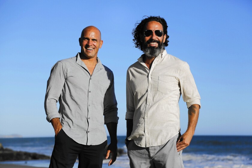 Surfer Kelly Slater, left, and designer John Moore have teamed on Outerknown, a clothing line with surf roots, luxury prices and a principle of sustainability.
