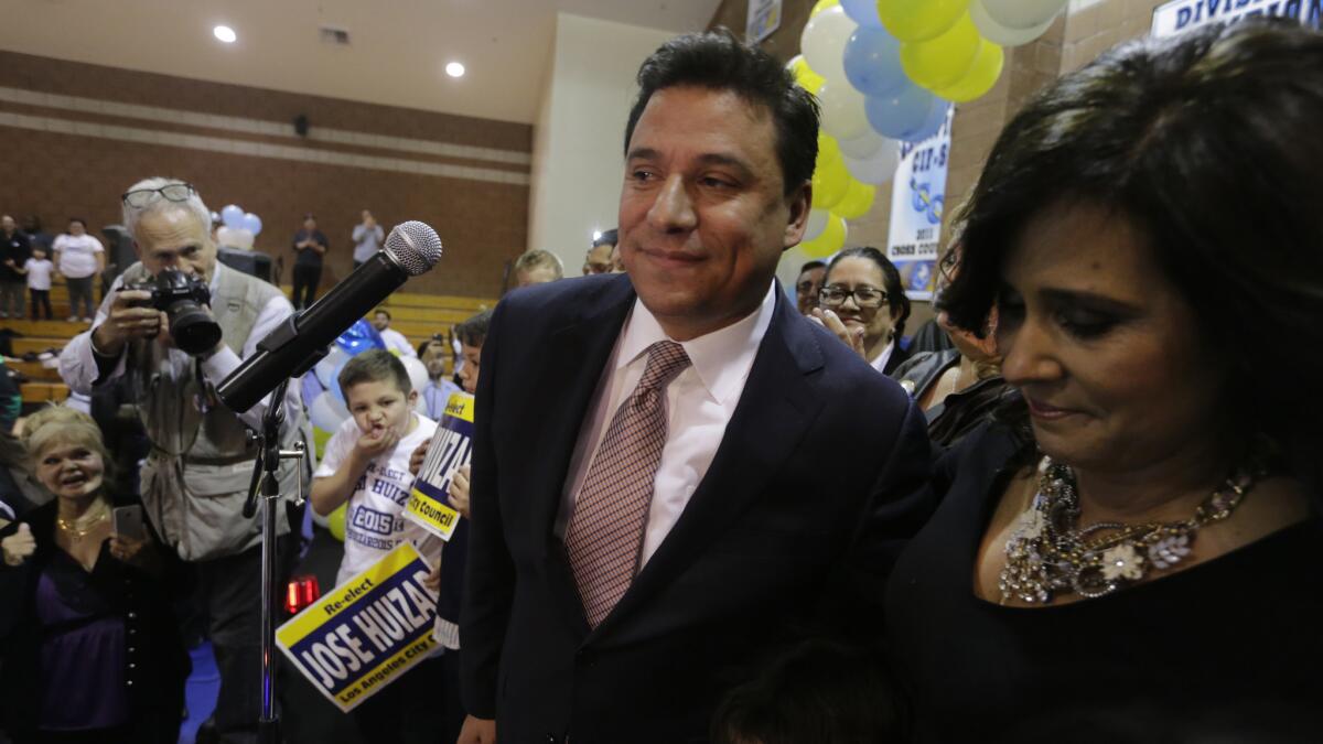 Los Angeles City Councilman Jose Huizar with his wife, Richelle, at his election night party in 2015. Richelle Huizar says she is ending her campaign for his seat.