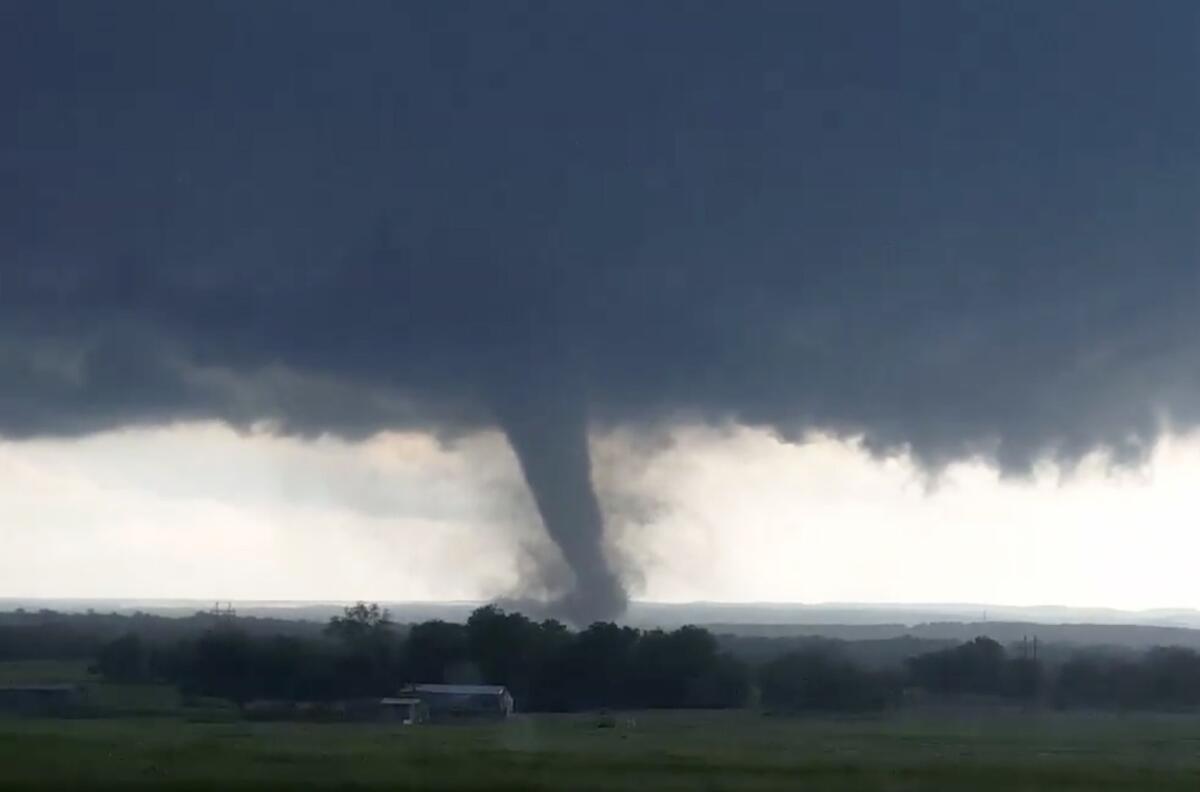 This image made from a video taken through a car window shows a tornado near Wynnewood, Okla., on Monday.
