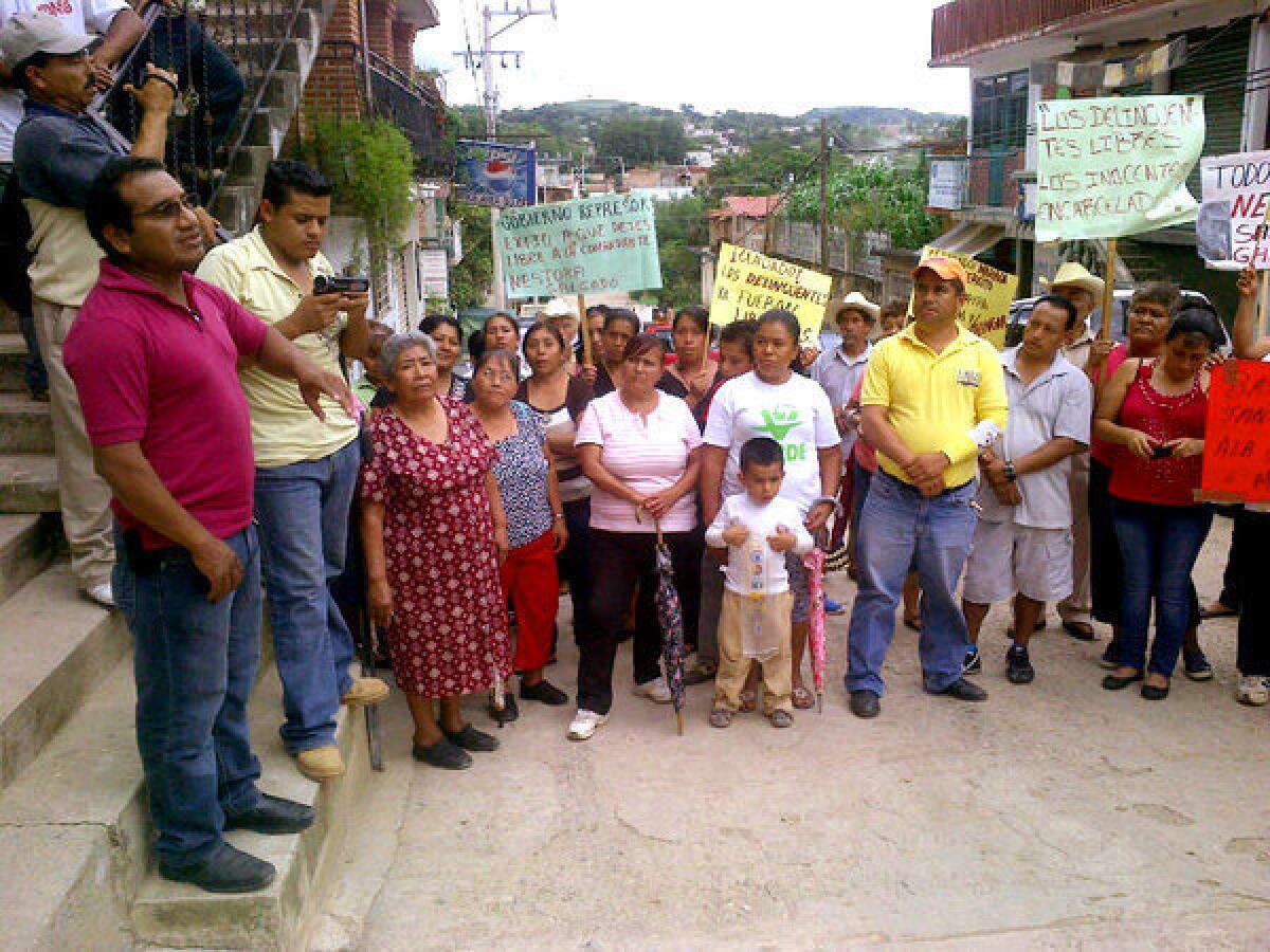 Nestora Salgado's attorney, Vidulfo Rosales of the Tlachinollan human rights organization, left, updates townspeople on Salgado's case during a meeting in Olinala.