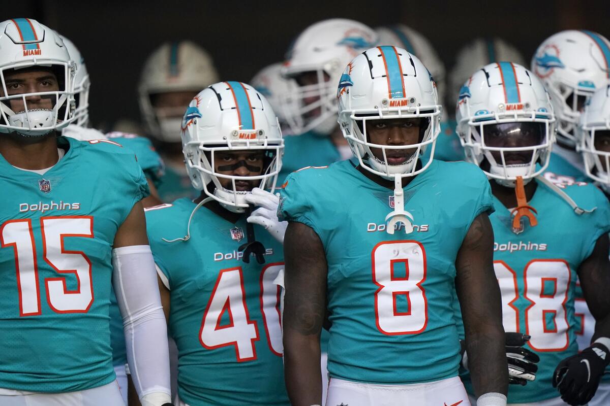 Miami Dolphins players wait to go out on the field before the start of a preseason game against the Las Vegas Raiders.