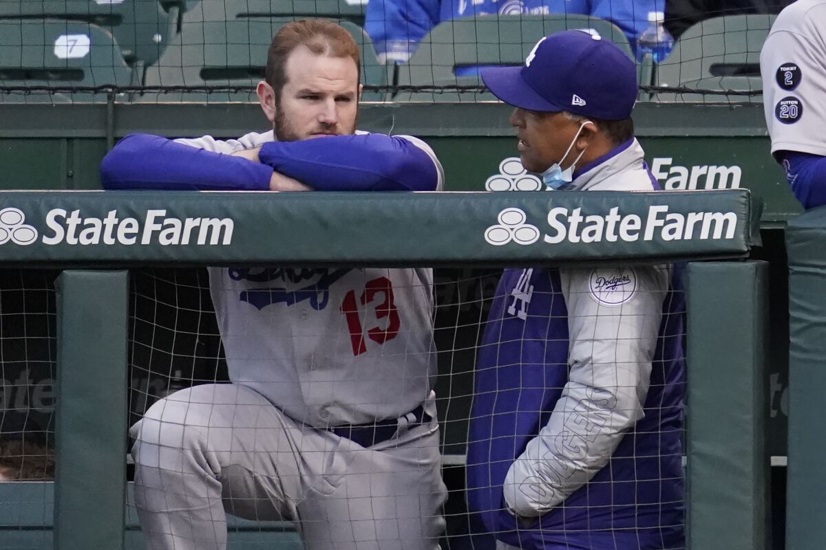 Dodgers first baseman Max Muncy listens to manager Dave Roberts during Wednesday's loss to the Chicago Cubs.