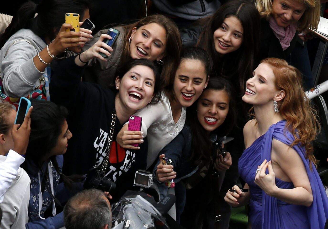 Jessica Chastain, right, poses with fans as she arrives for the screening of "Foxcatcher" during the 67th annual Cannes Film Festival in Cannes, France, on May 19, 2014.