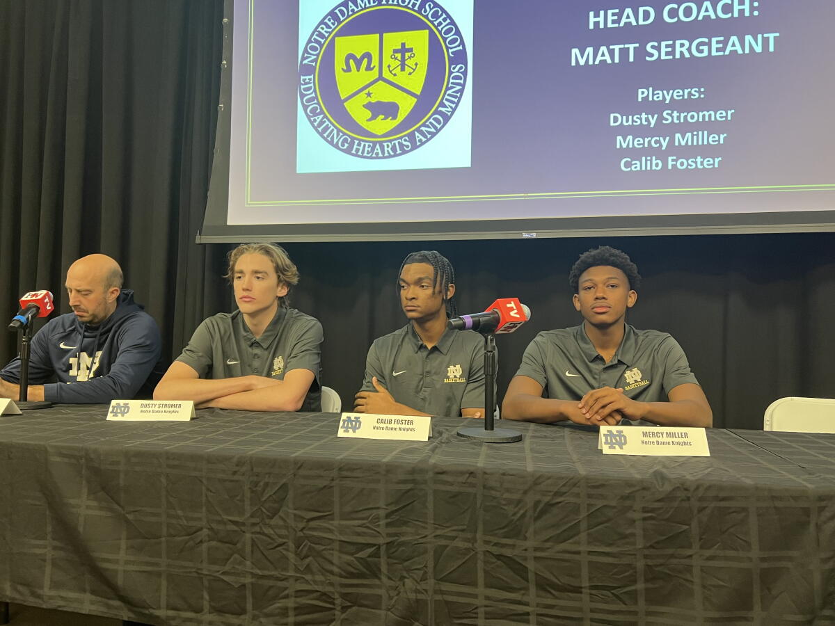 Notre Dame High basketball players (from second left) Dusty Stromer, Caleb Foster and Mercy Miller at a news conference.
