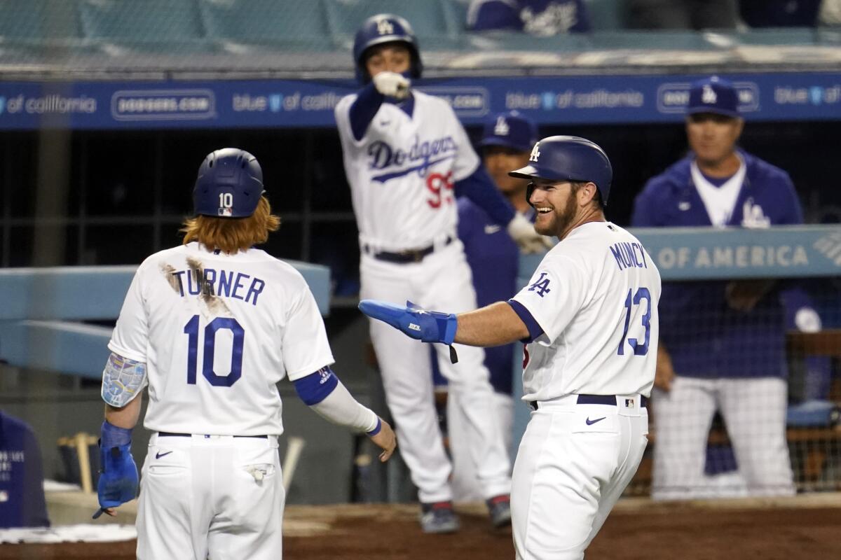 Justin Turner and Max Muncy after they scored on a double by Matt Beaty during the fourth inning.
