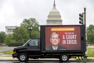 A mobile billboard showing Justice Roberts and a sign "The face of the court in crisis" drives near the U.S. Capitol 
