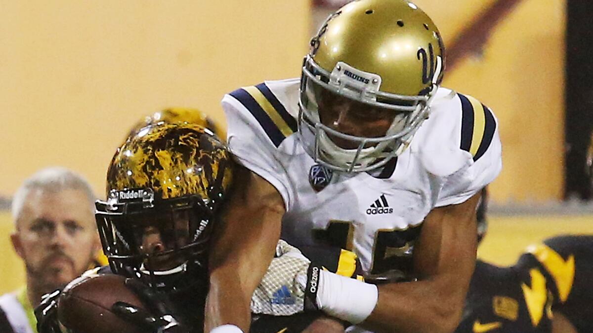 Arizona State wide receiver Jaelen Strong, left, makes a catch in front of UCLA defensive back Priest Willis during a game on Sept. 25, 2014.