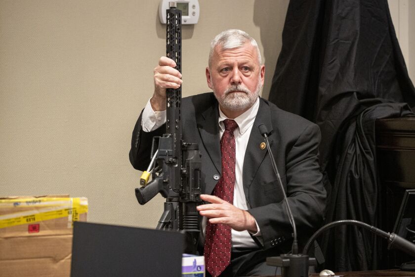 SLED agent Jeff Croft holds a .300 blackout rifle while being cross-examined by defense attorney Jim Griffin during Alex Murdaugh's double murder trial at the Colleton County Courthouse in Walterboro, S.C., Tuesday, Jan. 31, 2023. The 54-year-old attorney is standing trial on two counts of murder in the shootings of his wife and son at their Colleton County home and hunting lodge on June 7, 2021. (Andrew J. Whitaker/The Post And Courier via AP, Pool)