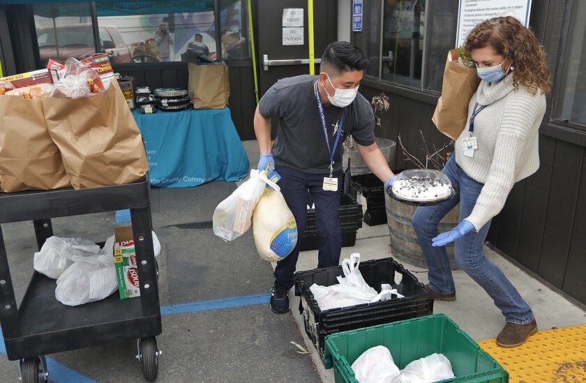 Don Hoa, left, carefully hands CEO Christy Ward, a chocolate cake.