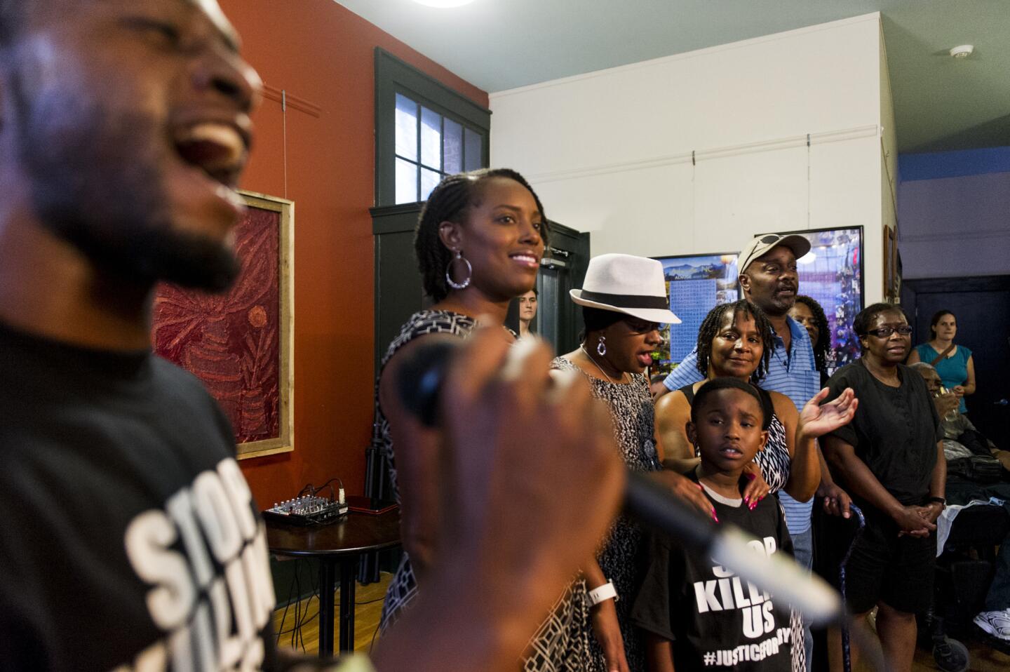 Jamal Cash leads Jai "Jerry" Williams' family and community in song at Williams' birthday party at the Block off Biltmore in Asheville, N.C., on July 12. Williams, who was fatally shot by police 10 days earlier, would have been 36.