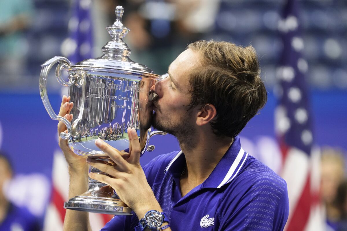 FILE - Daniil Medvedev, of Russia, kisses the championship trophy after defeating Novak Djokovic, of Serbia, in the men's singles final of the U.S. Open tennis championships, Sunday, Sept. 12, 2021, in New York. Tennis players from Russia and Belarus will not be allowed to play at Wimbledon this year because of the war in Ukraine, the All England Club announced Wednesday, April 20, 2022. (AP Photo/John Minchillo, File)