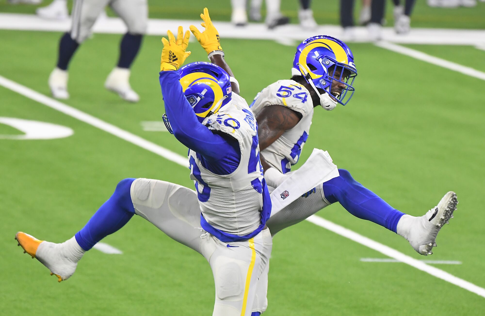 Rams linebackers Samson Ebukam and Leonard Floyd celebrate their win over the Dallas Cowboys.