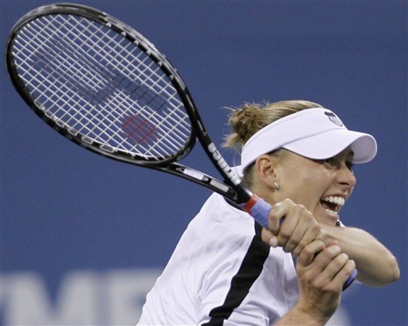 Vera Zvonareva of Russia returns a shot during a match against Andrea Petkovic of Germany at the U.S. Open tennis tournament in New York, Monday, Sept. 6, 2010. (AP Photo/Mike Groll)