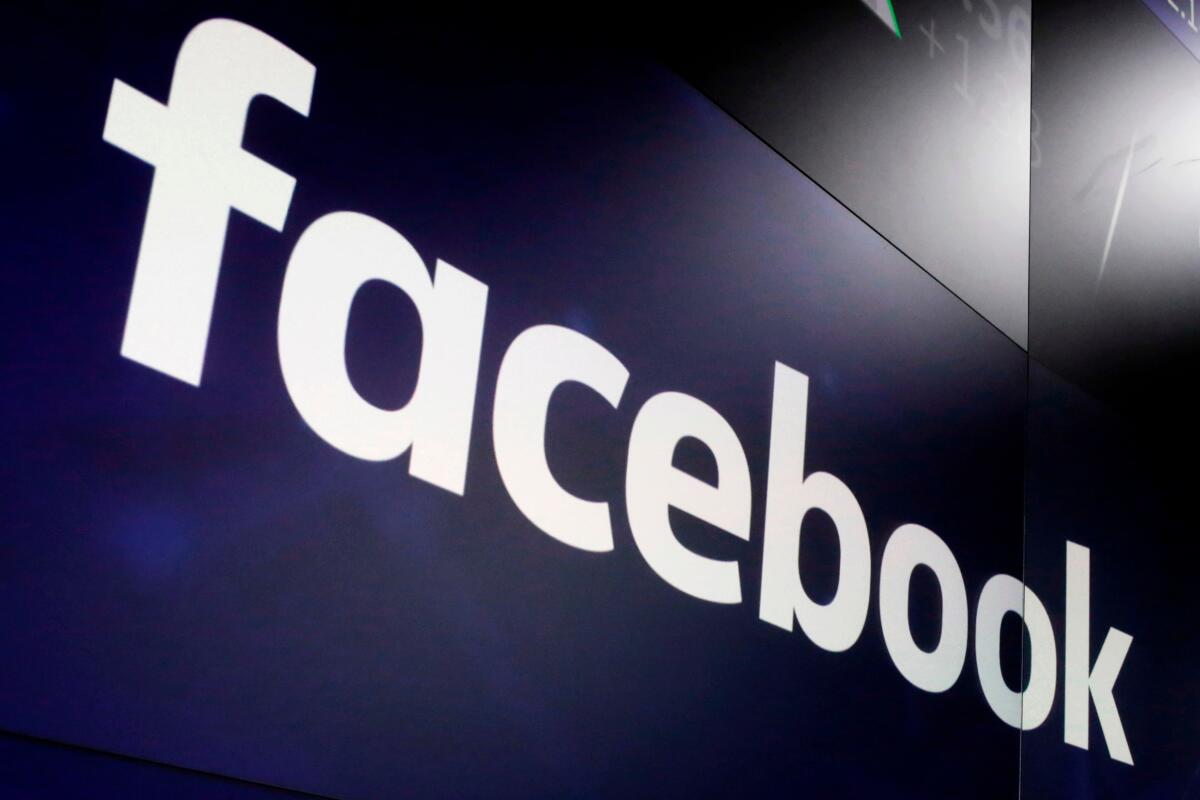 FILE - In this March 29, 2018, file photo, the logo for Facebook appears on screens at the Nasdaq MarketSite in New York's Times Square. Facebook has apologized for putting a “primates" label on a video of Black men, in June 2021, according to a report in the New York Times. (AP Photo/Richard Drew, File)