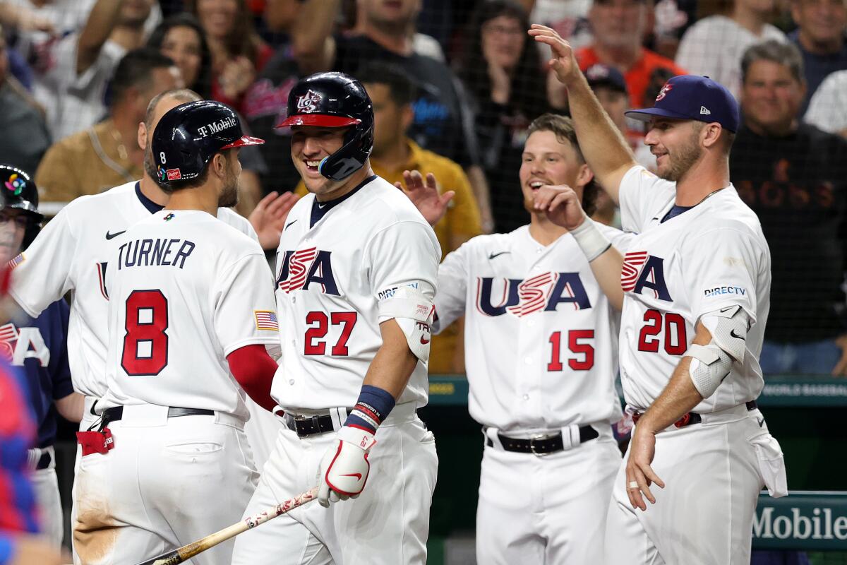 Trea Turner, left, celebrates with his U.S. teammates after hitting a three-run home run in the sixth inning against Cuba.