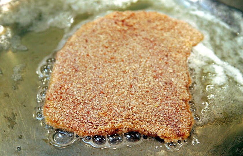 EASY ENTREE: The key to a good schnitzel  pork cutlet dipped in flour, egg and bread crumbs  is in the frying.
