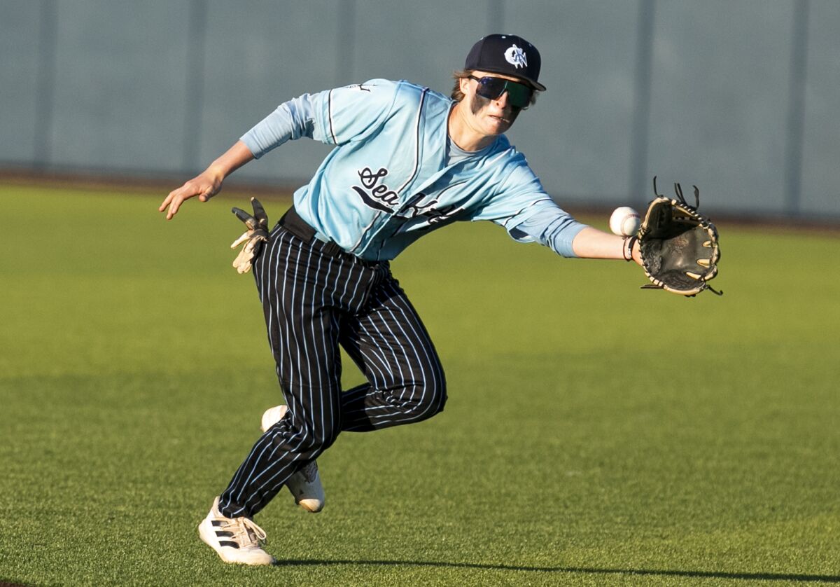 Corona del Mar's Ganon Overfelt makes a play during a Battle of the Bay baseball game on Friday at Orange Coast College.
