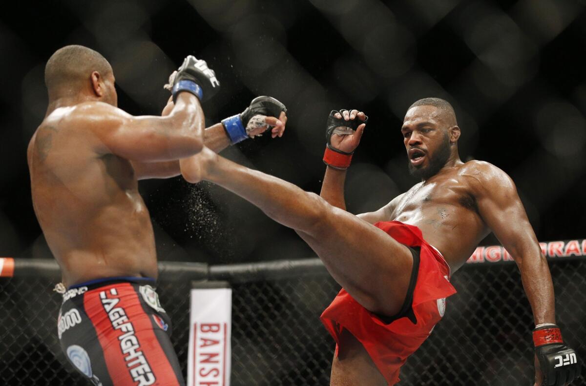 Jon Jones, right, kicks Daniel Cormier during their light heavyweight mixed martial arts title bout at UFC 182 back in January.