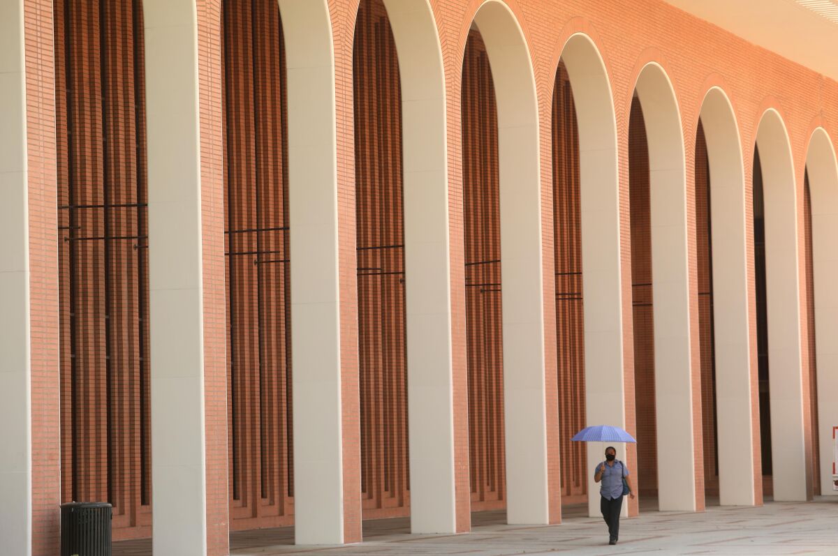 USC employee Flor Pena walks through a lonely part of the campus on Monday.