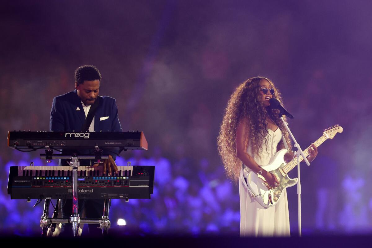 Two people perform during the closing ceremony of the 2024 Paris Olympics 