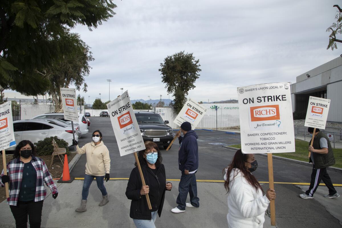 People march with signs.