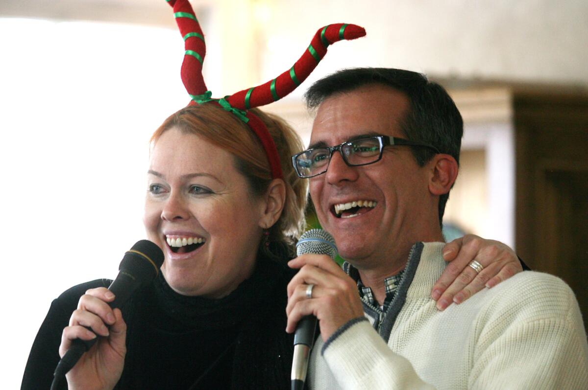 L.A. Mayor Eric Garcetti, shown singing Christmas songs with Cat Herzon when he was a city councilman in 2011, will sing "New York, New York" on "Jimmy Kimmel Live" if the Kings lose to the Rangers in the Stanley Cup Final.