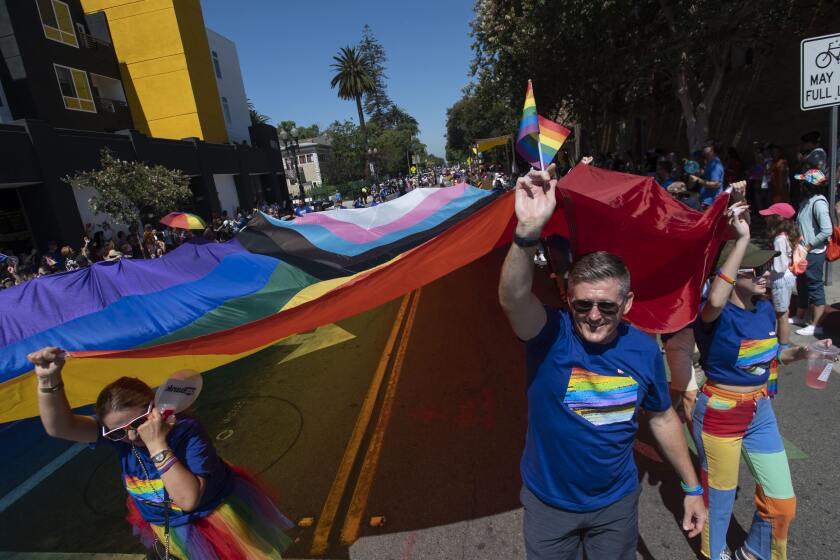 Participants in the OC Pride Parade carry an oversized Progress Pride Flag as the event begins along Third St. in Santa Ana on Saturday, June 25, 2022. (Photo by Paul Rodriguez)
